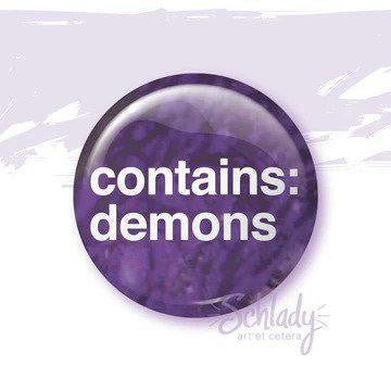 1.25 purple button pin with white contains: demons text on a light background.