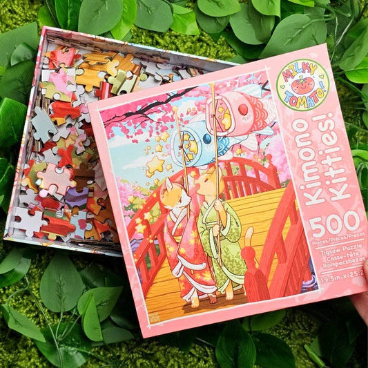 Kimono Kitties 500-piece puzzle with cats in kimonos on a bridge and colorful pieces.