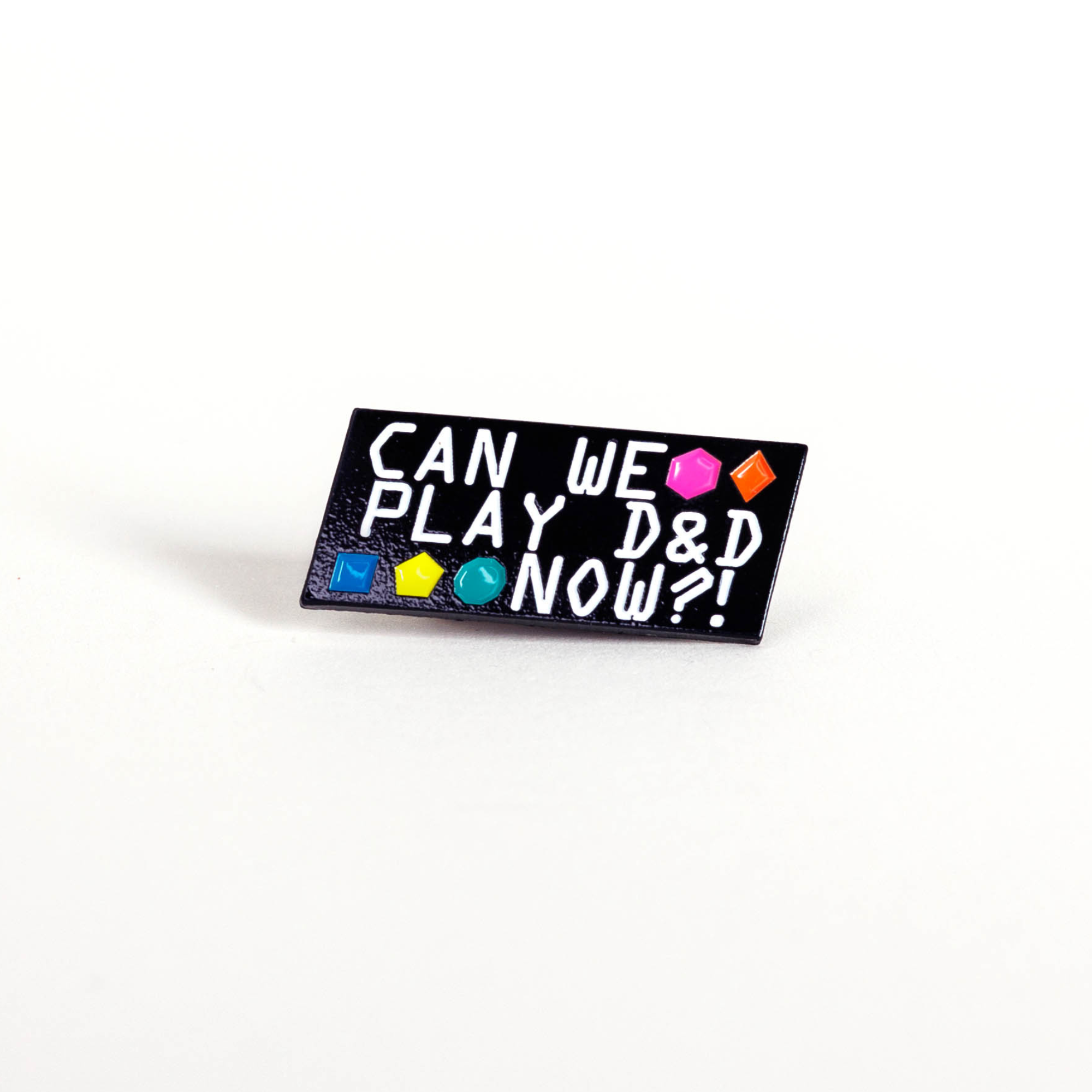 Can We Play D&D Now? black enamel pin with dice symbols and bold text.