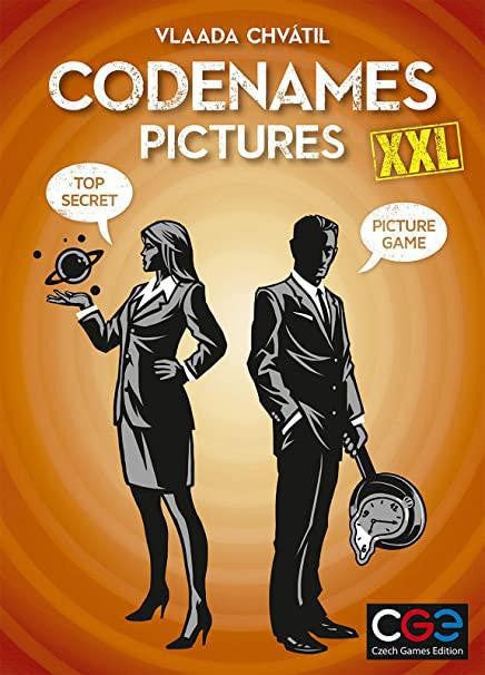 Codenames Pictures XXL game box featuring two people in suits, one wearing a hat, one with a top secret icon on orange background.