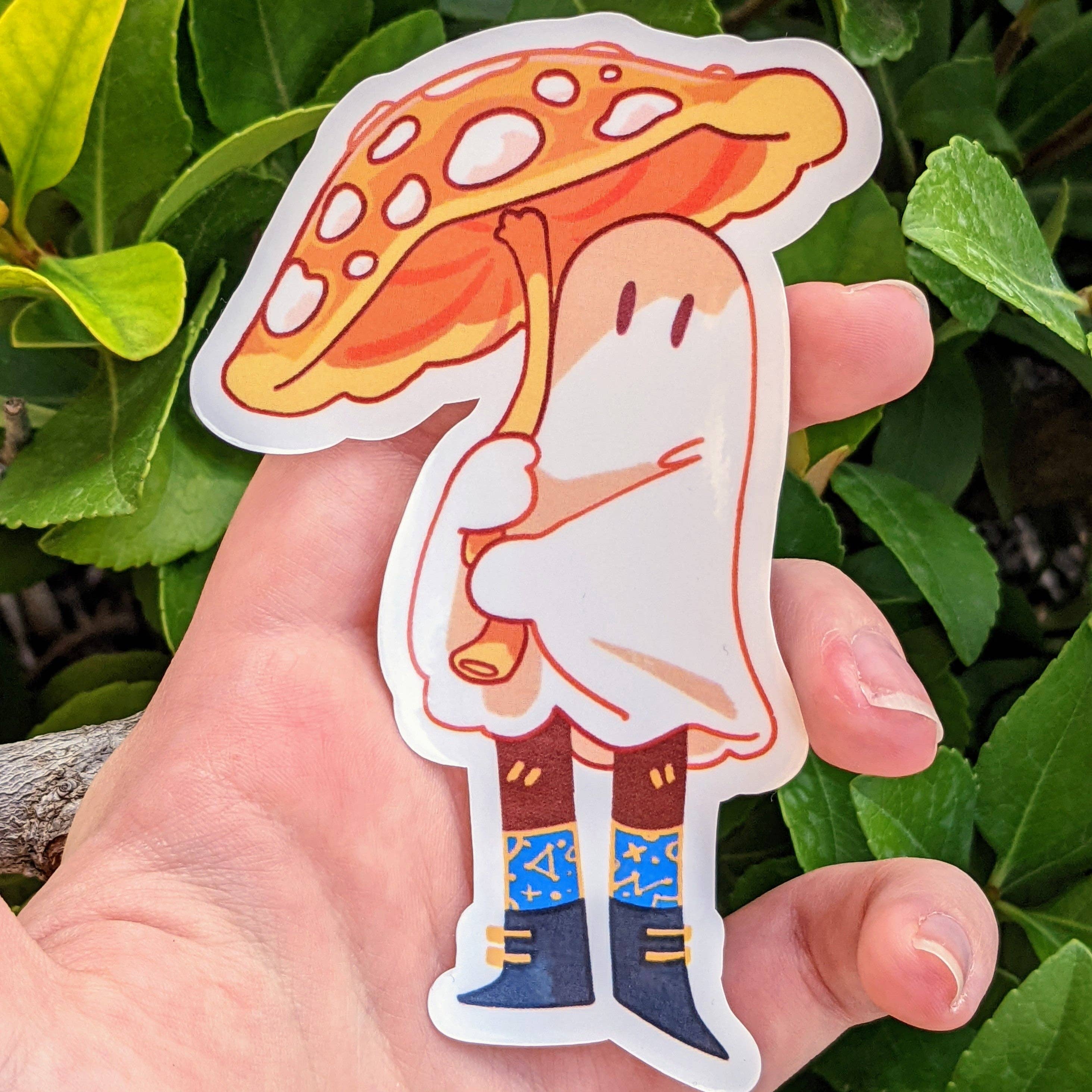 Cute Ghost Stickers : V6, showing a mushroom ghost with boots, umbrella, and green leaves, held in a hand.