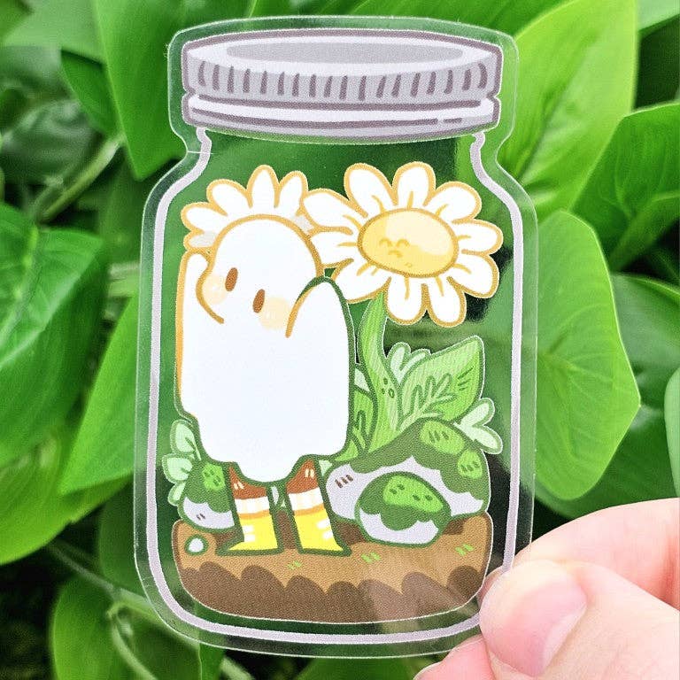 Daisy Ghost In A Jar Transparent Sticker held in a hand.