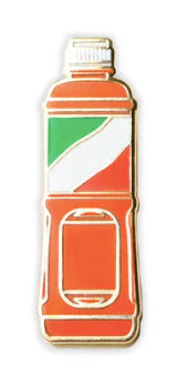 Tajin enamel pin shaped like a red bottle with a green, white, and red label.