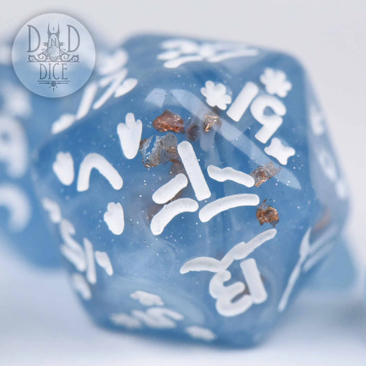 Penguin Plunge die in blue resin with white numbers and copper flakes.