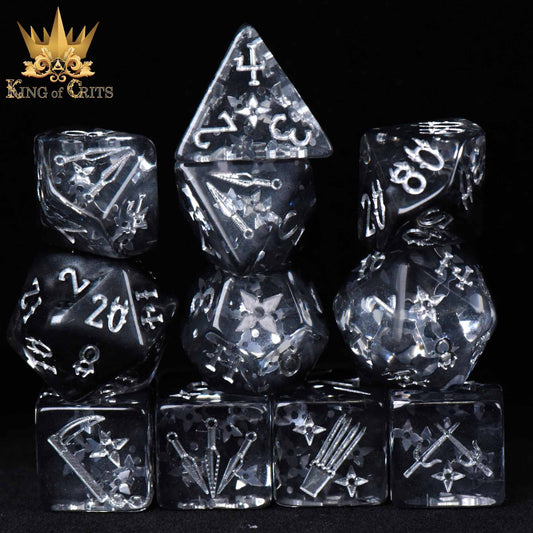 The Art of Stealth - 11 Dice Set with clear resin dice and white designs. King of Crits logo in background.
