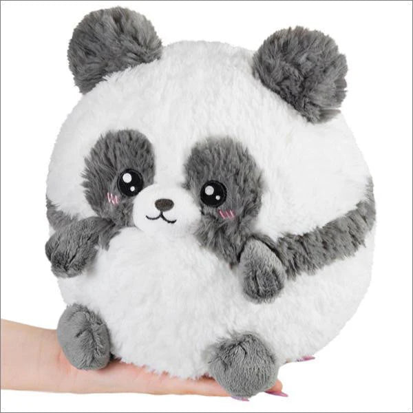 Mini Squishable Baby Panda III (7) plush, round and fluffy, with big black eyes and pink cheeks, shown resting on a hand.