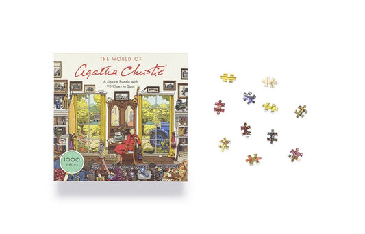 World of Agatha Christie 1000 Piece Puzzle box with puzzle pieces spread out on a white surface.
