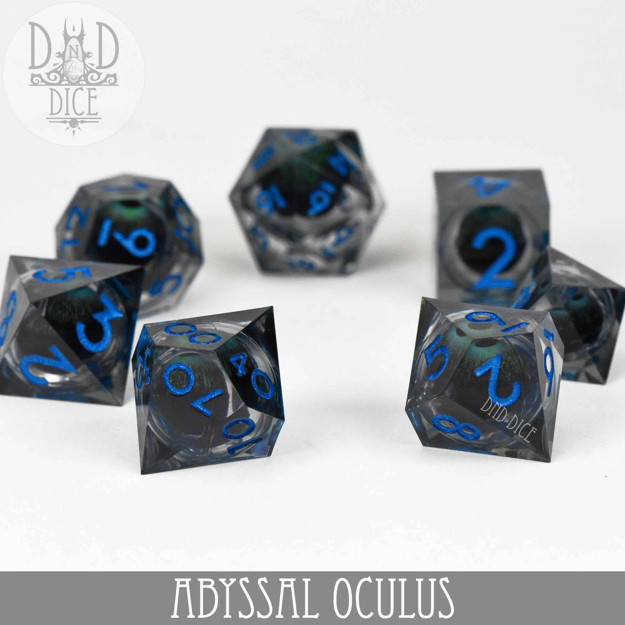 Abyssal Oculus (Liquid Core) seven-piece resin dice set: smoky gray with swirling cores and bright blue numbers.