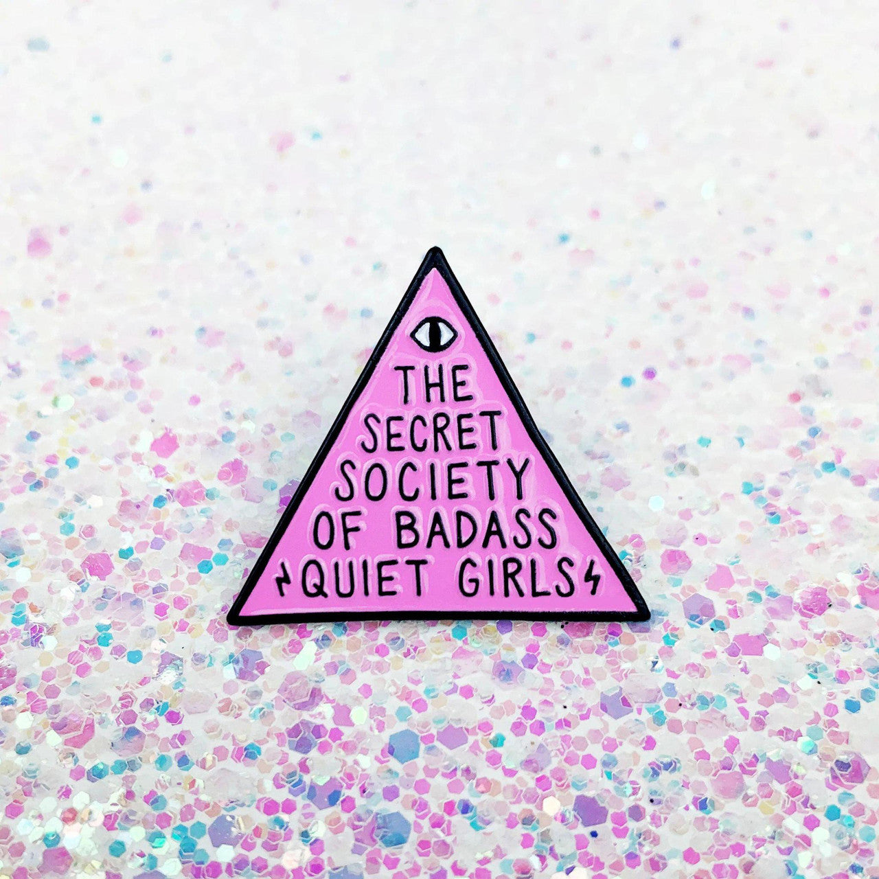 Badass Quiet Girls Enamel Pin with a pink triangle, glittery background, and the text message.