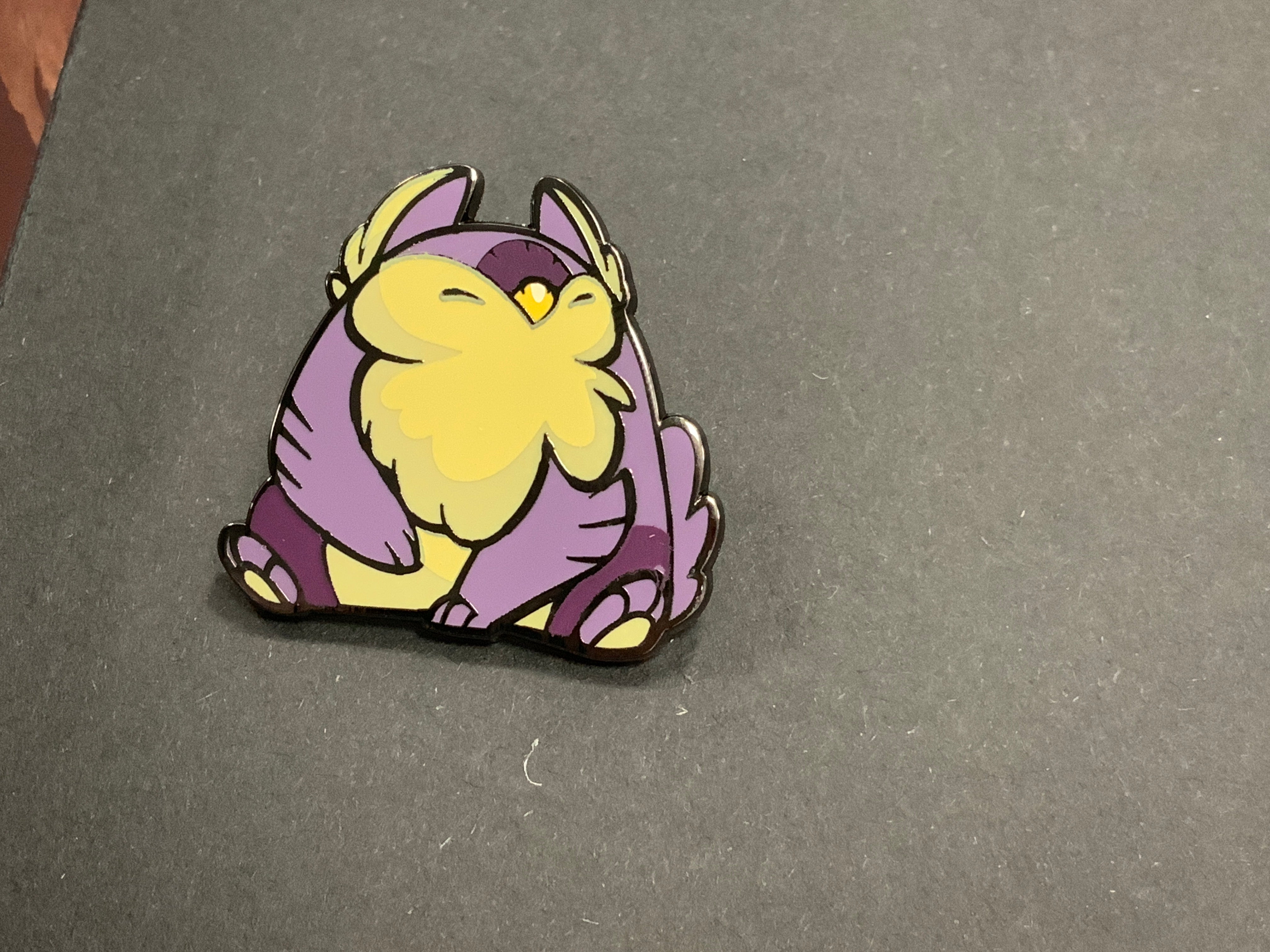 Heliana monster hunting pin featuring Tarling/Owlbear on a dark gray surface.