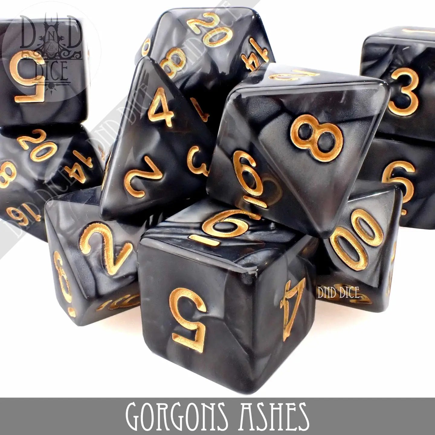 The Gorgons Ashes 11 Piece Dice Set with black and gold polyhedral dice.