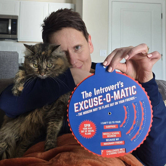 The Introverts Excuse-o-Matic excuse generator held by a woman with a cat.