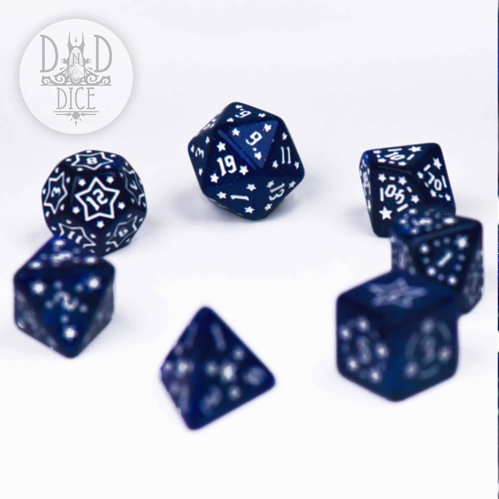Star Spangled set of seven blue resin polyhedral dice with white markings.