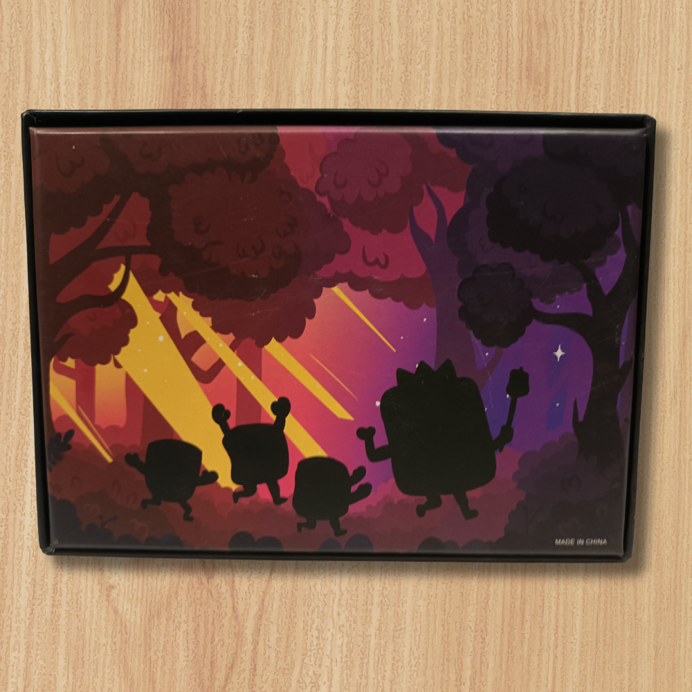 Roast: A Game of Sinister Sweetness board game featuring four cartoon figures in a colorful forest setting.
