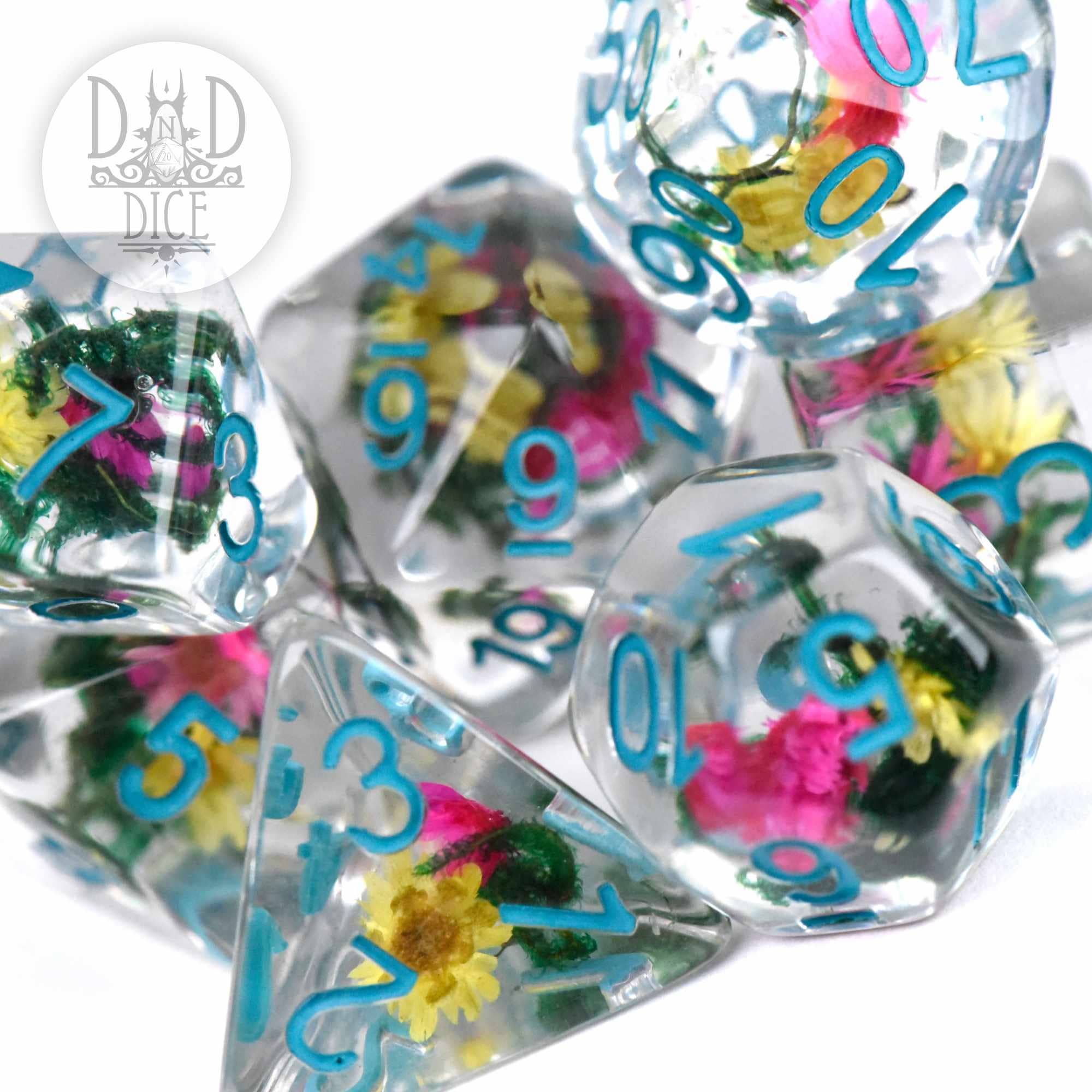 Vintage Bloom 7-piece clear resin dice set with blue numbers and embedded colorful flowers.