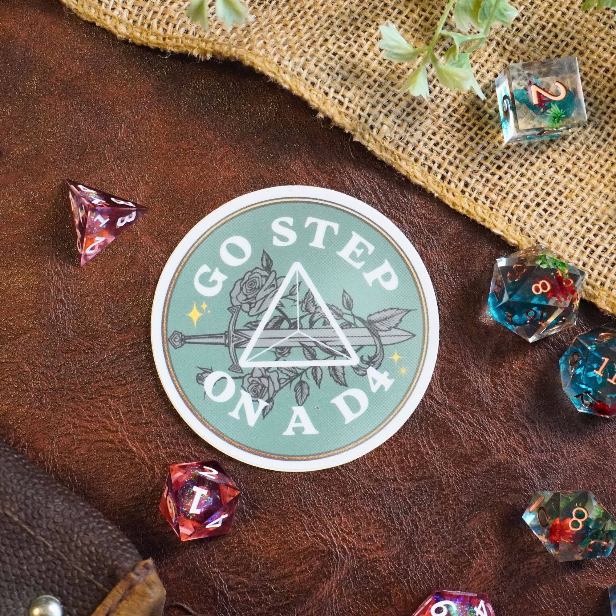 Go Step on a D4 Sticker with the quote and colorful dice.