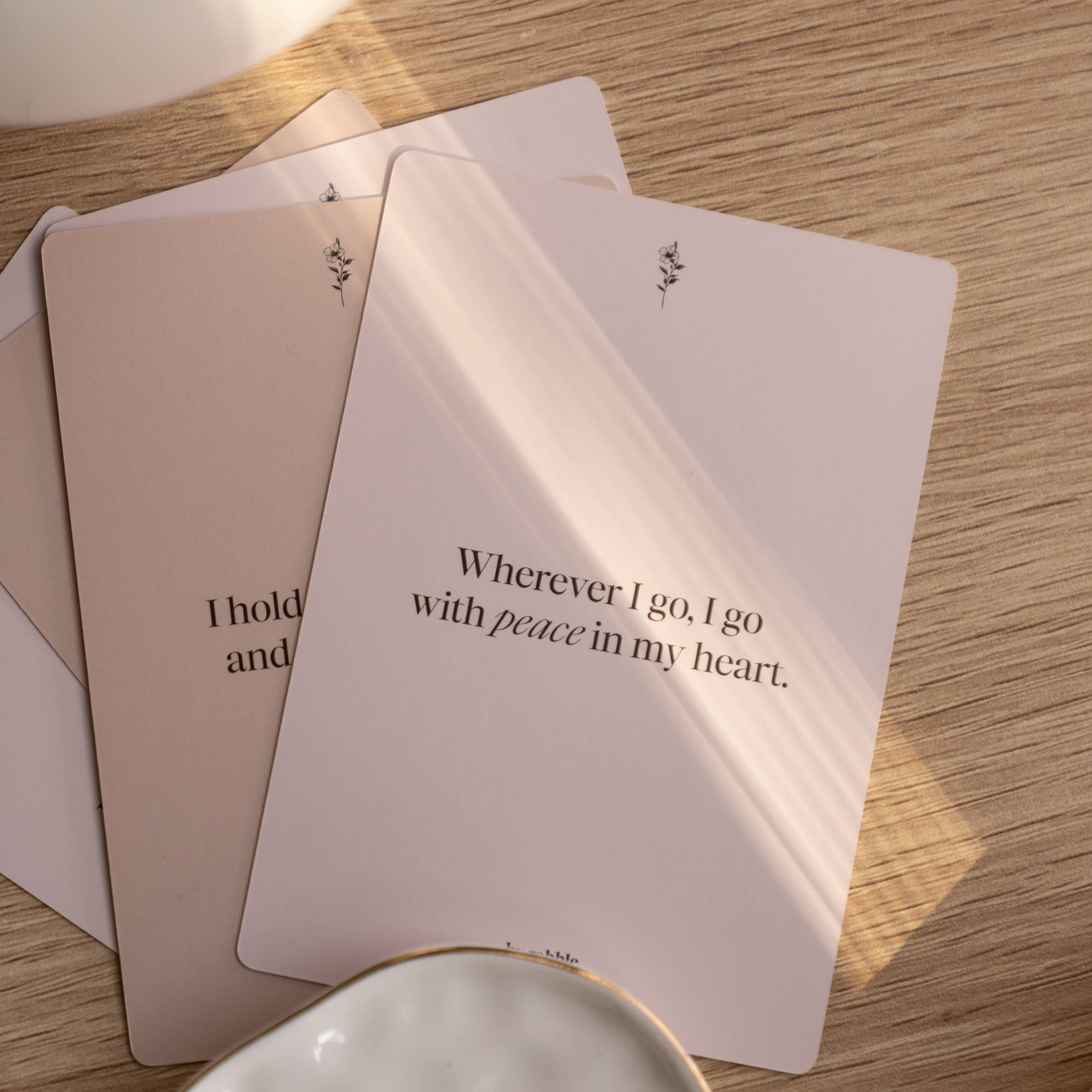 Three Self-Care & Affirmations cards; one card reads, Wherever I go, I go with peace.