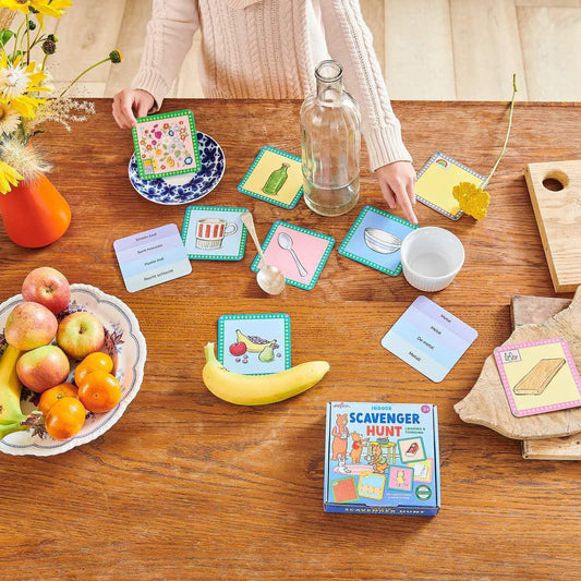Indoor Scavenger Hunt educational game with cards and items displayed on a wooden table.