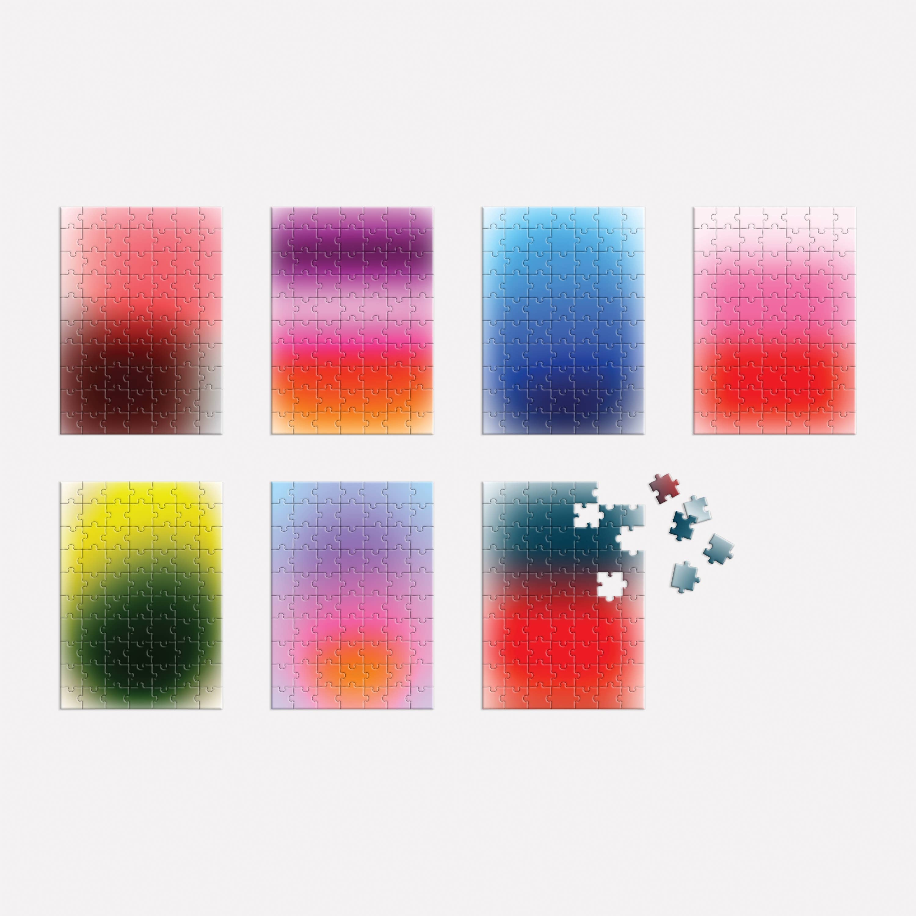 Seven puzzles from the 7 Days of Mindfulness gradient set, with one puzzle partially assembled.