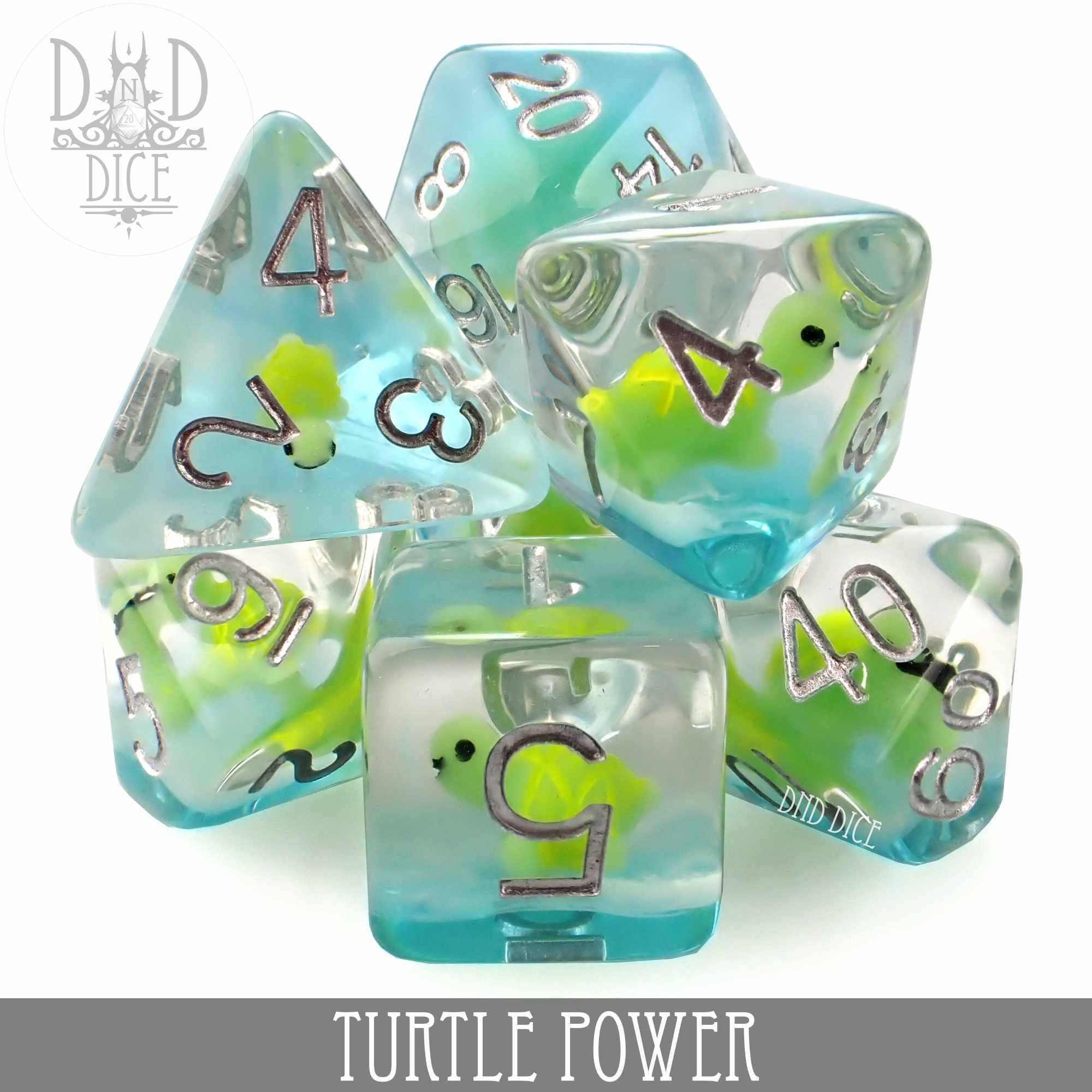Turtle Power 7-dice set made of clear blue-green resin, each die contains a small green turtle figure inside.