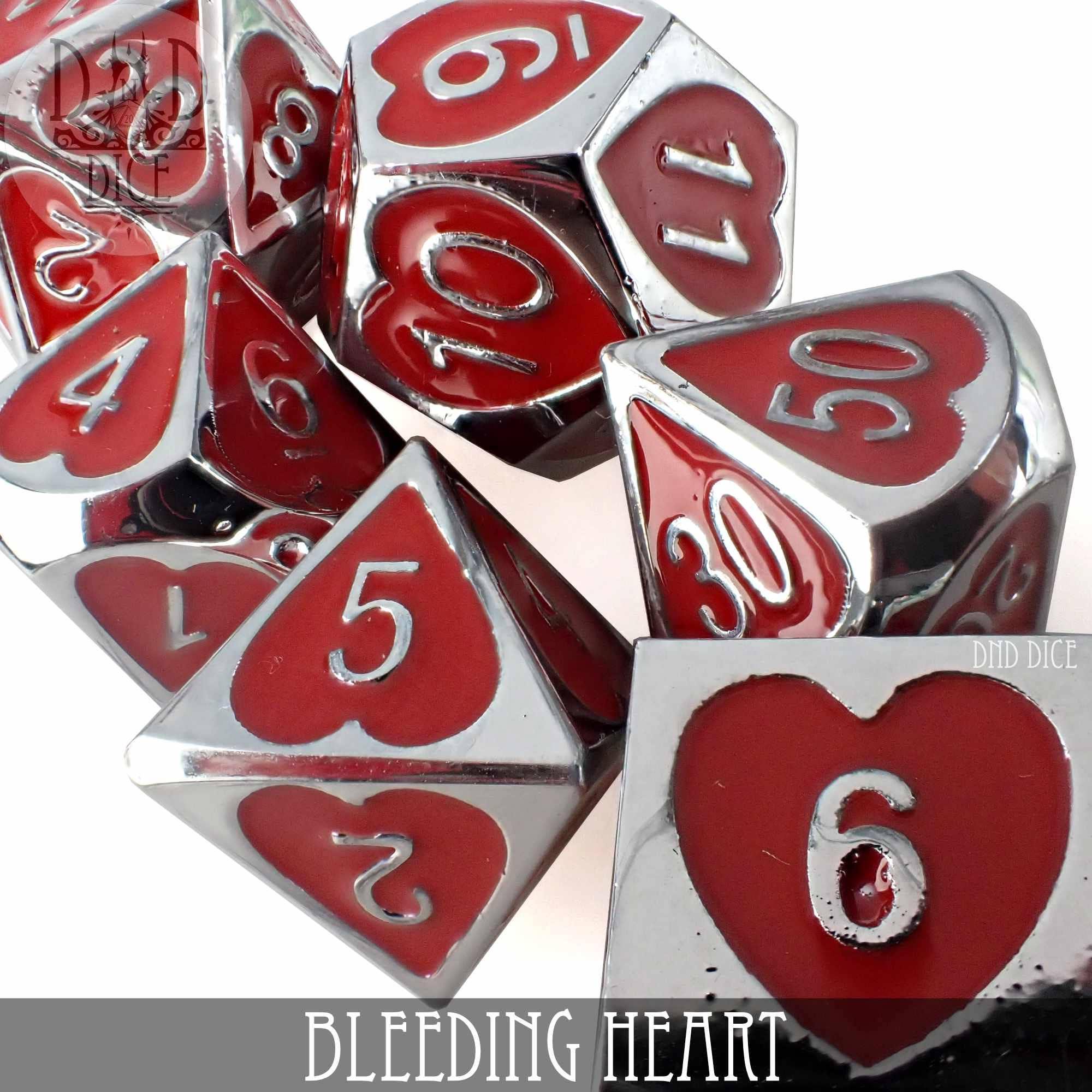 Bleeding Heart metal 7-piece RPG dice set: silver dice with red heart-shaped enamel insets and silver numbers.