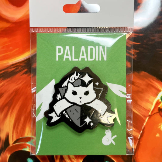 Paladin enamel pin of a white cat holding a sword and ribbon, labeled PALADIN, with black nickel plating.