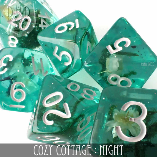 Teal resin dice with white numbers and small flowers inside, Cozy Cottage Night variant.