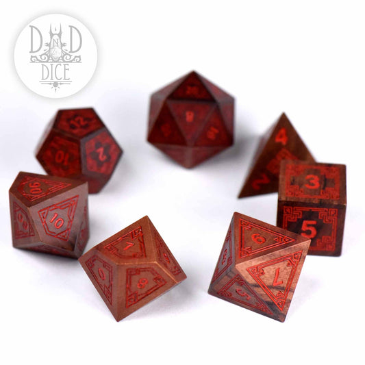 Seven-piece Guibourtia wood dice set, Interlinked - Wood (Gift Box) variant; DnD Dice logo in corner.