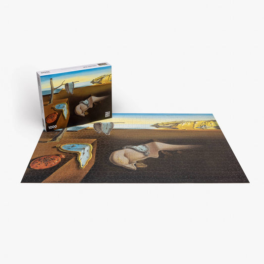 Completed 1000-piece Salvador Dali Persistence of Memory puzzle with original box.