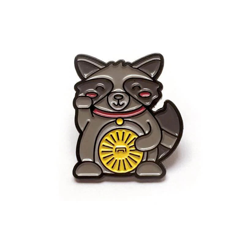 Kolorspun Pins Lucky Raccoon Enamel Pin showing a raccoon raising one paw and holding a yellow coin.