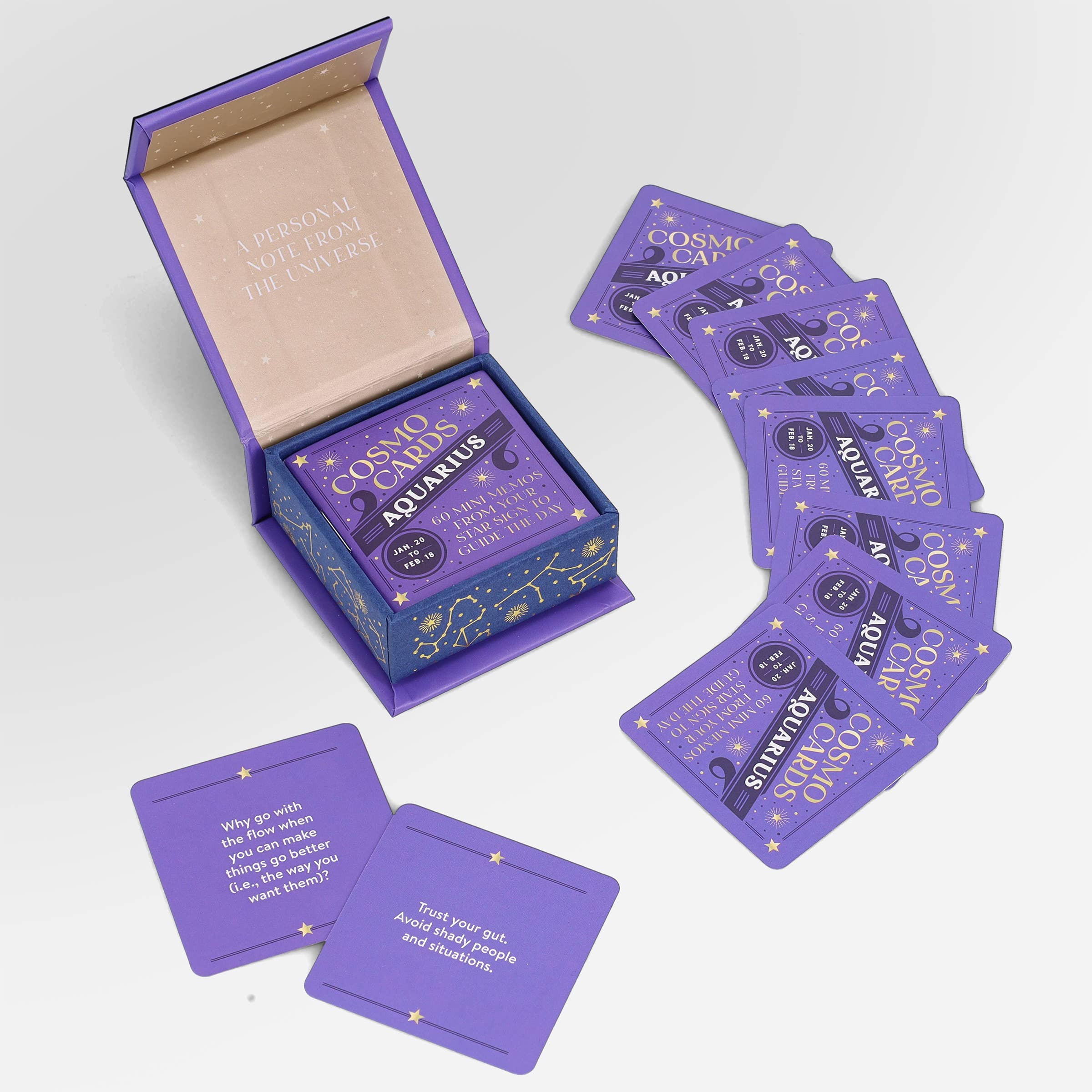 Cosmo Cards oracle deck with purple cards displaying quotes, prompts, and affirmations.