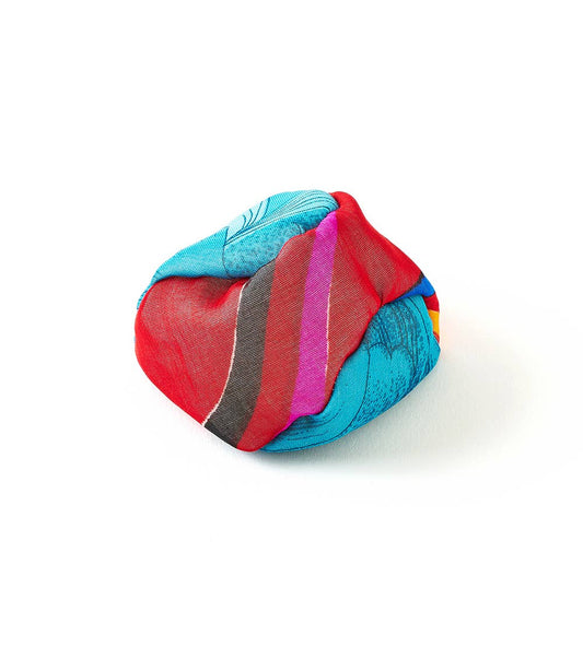 Sari Footbag Hacky Sack with red, blue, and black patterns on white, handmade by women artisans.