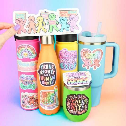 Turtles Soup Yall Means All queer vinyl sticker shown on a colorful mug, held by a hand.
