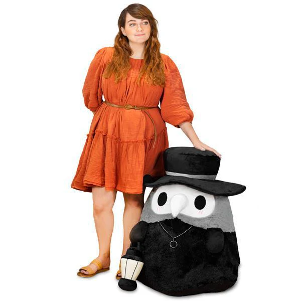 Massive Plague Doctor Squishable with glow-in-the-dark lantern next to woman in orange dress.