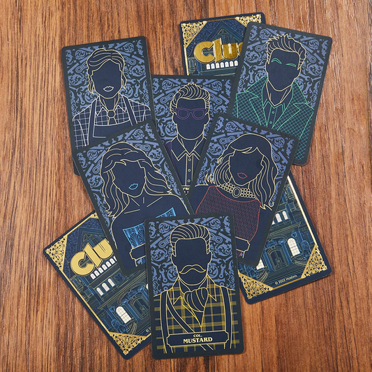 Eight Clue Signature Collection character cards from the collector’s edition game displayed on a wooden surface.