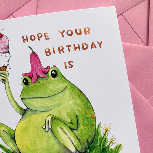The Unfrogettable Frog Birthday Card with a frog wearing a flower hat, holding ice cream, under Hope your birthday.