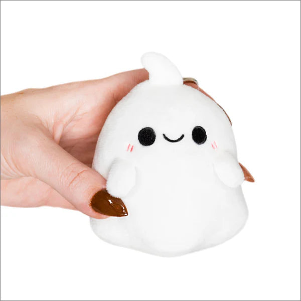 Micro Ghost Keychain, a small white plush with a smiling face and blushing cheeks, held in a hand.