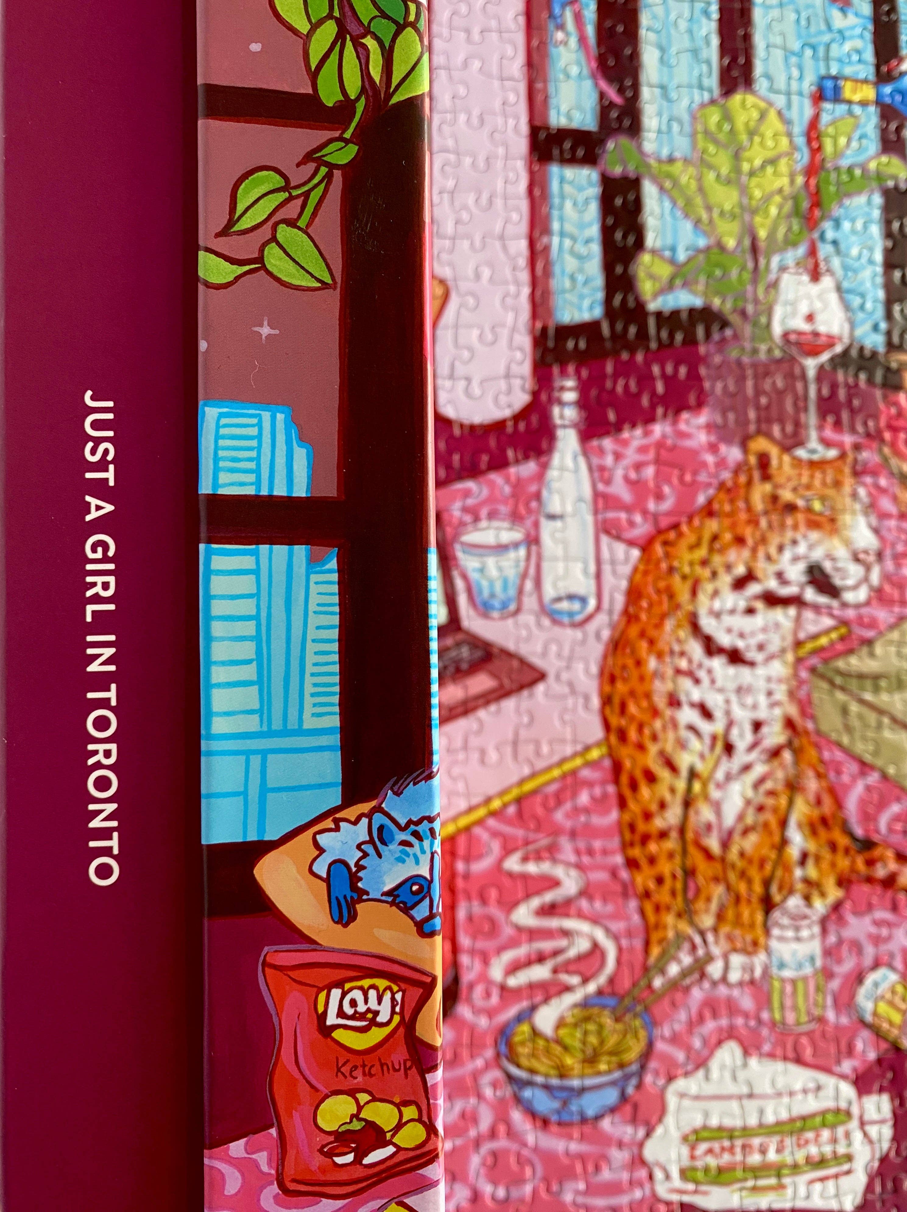 Just a Girl in Toronto book and 1000-piece puzzle by Jules Monson displayed side by side.