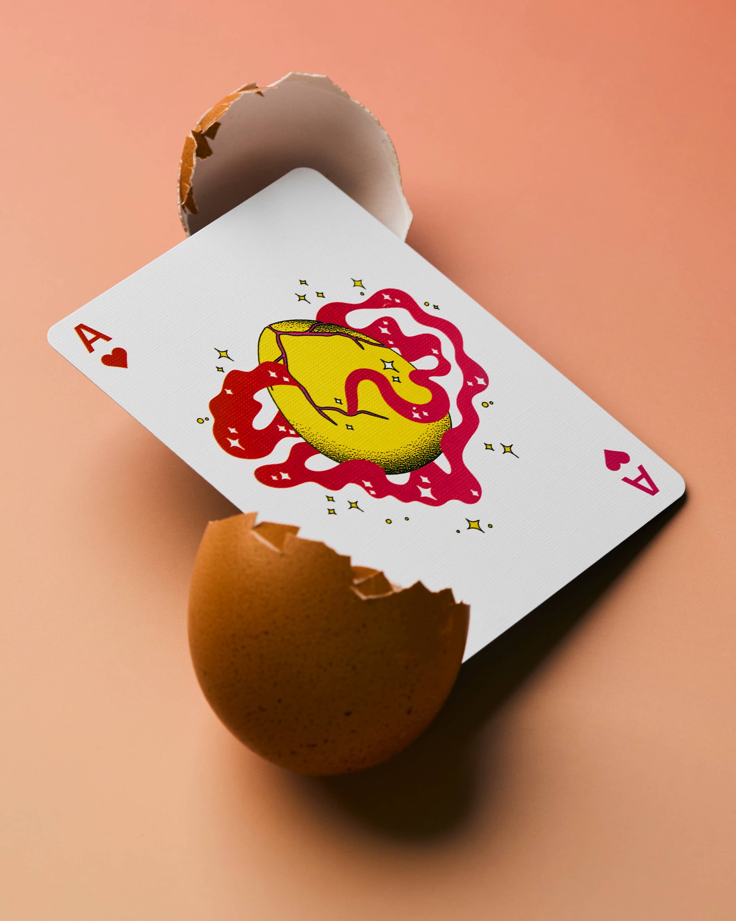 Meow Wolf playing card: ace of hearts with a cracked, dripping egg between two shell halves.