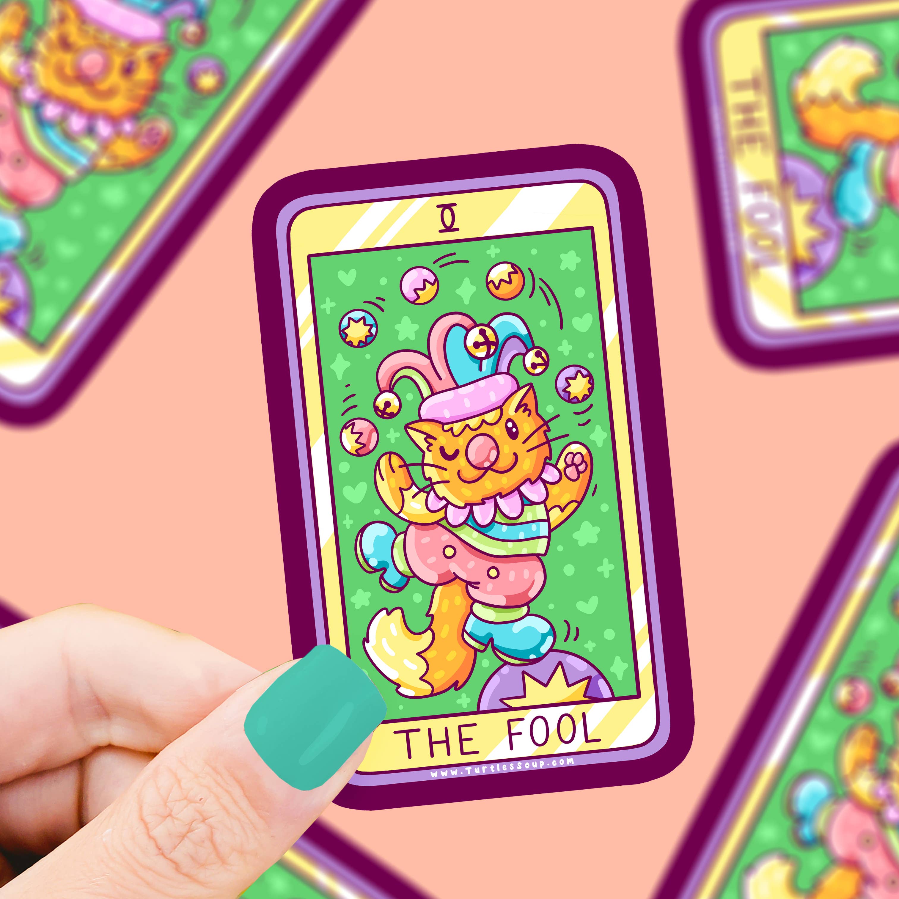 The Fool Kitty Cat Major Arcana Tarot Card Vinyl Sticker held in a hand, other cards blurred in the background.