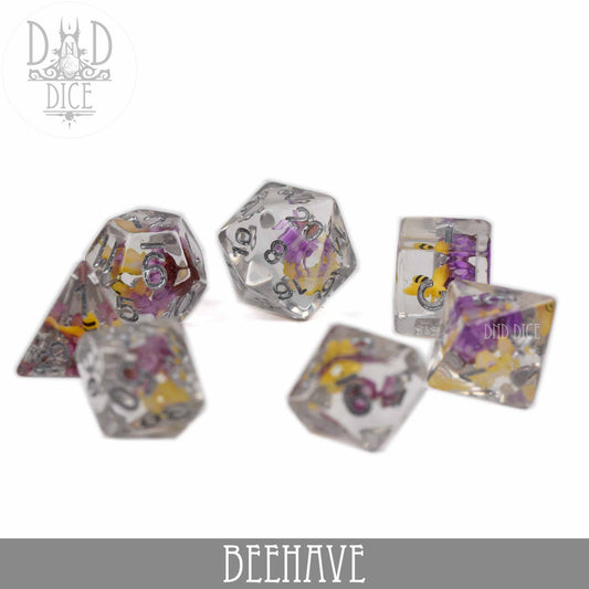 BEEhave 7-dice set in clear resin with yellow and purple inclusions.