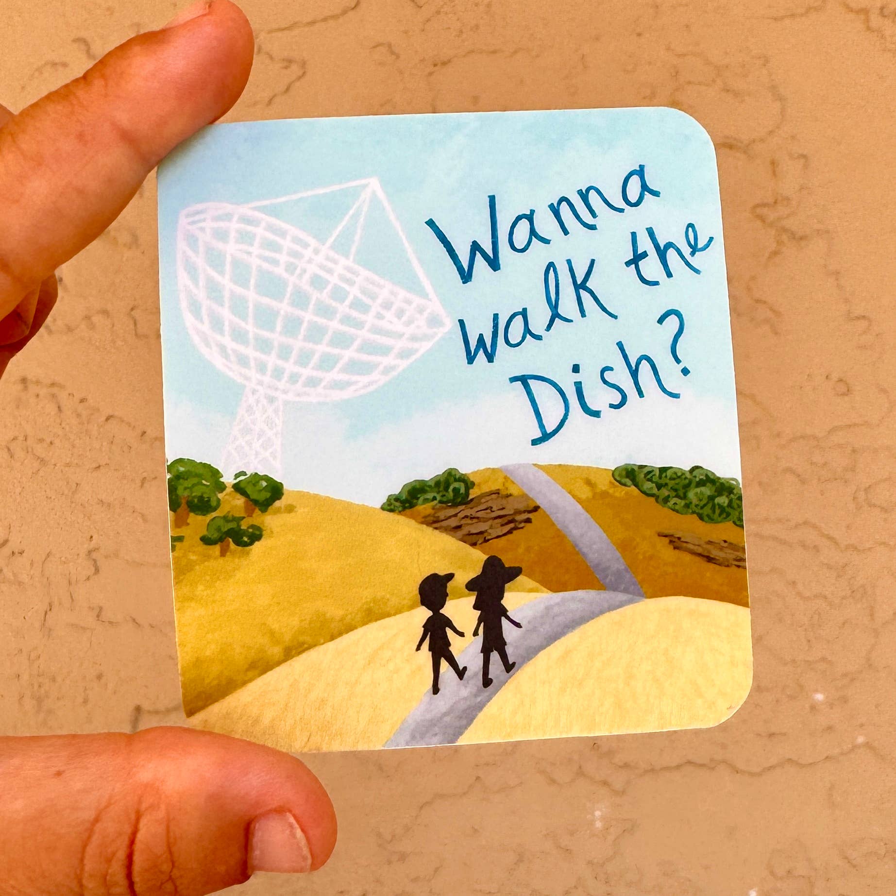 Wanna Walk the Stanford Dish Vinyl Sticker held in hand, features two people walking toward a radio dish.