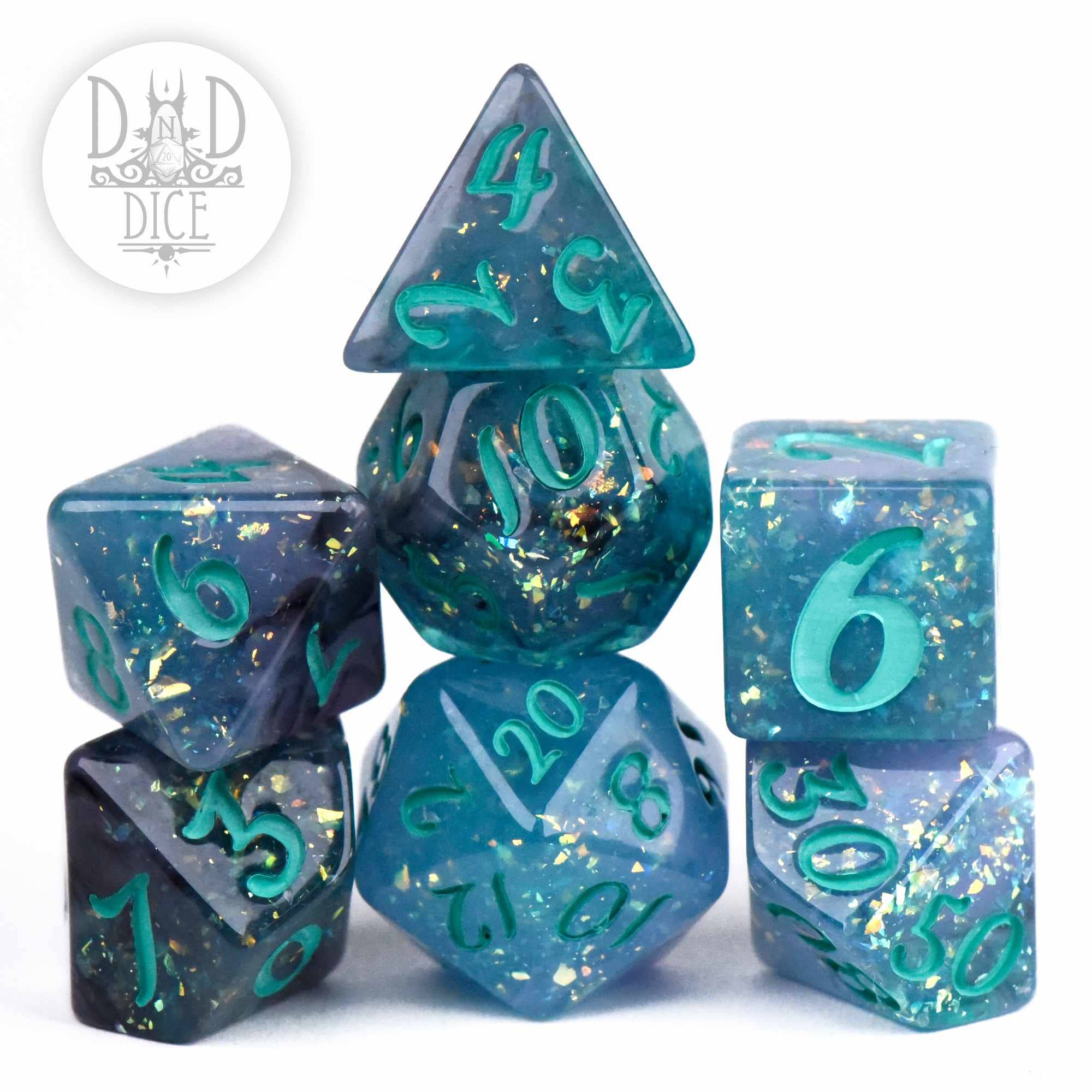 Gulf Stream 7-piece polyhedral dice set: blue and teal resin with gold leaf flakes and teal numbers.