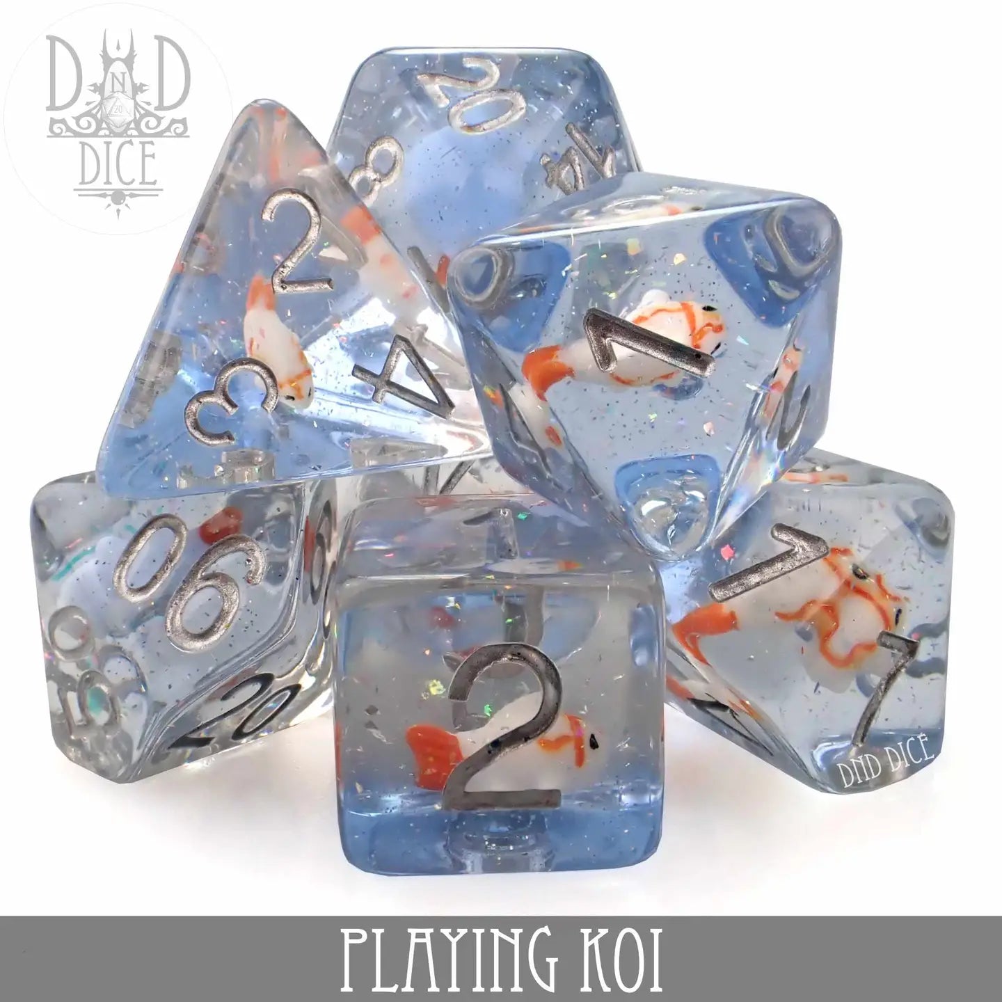Playing Koi Dice Set with translucent blue dice, koi fish inside, and silver numbers for DnD games.