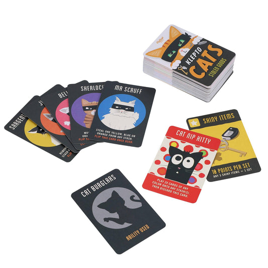 Klepto Cats card game cards displayed on a white surface, featuring illustrated card designs.