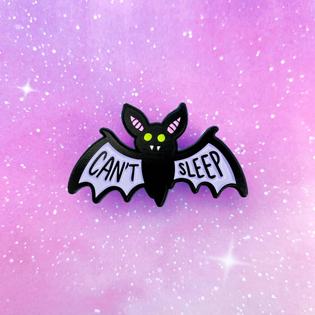 Band of Weirdos Cant Sleep enamel pin showing a cartoon bat with CANT SLEEP on its wings and a starry background.