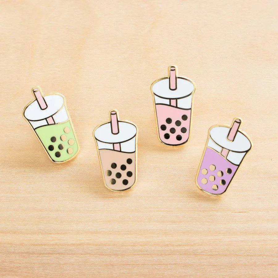 Four Boba Pin enamel pins in green, brown, pink, and purple.