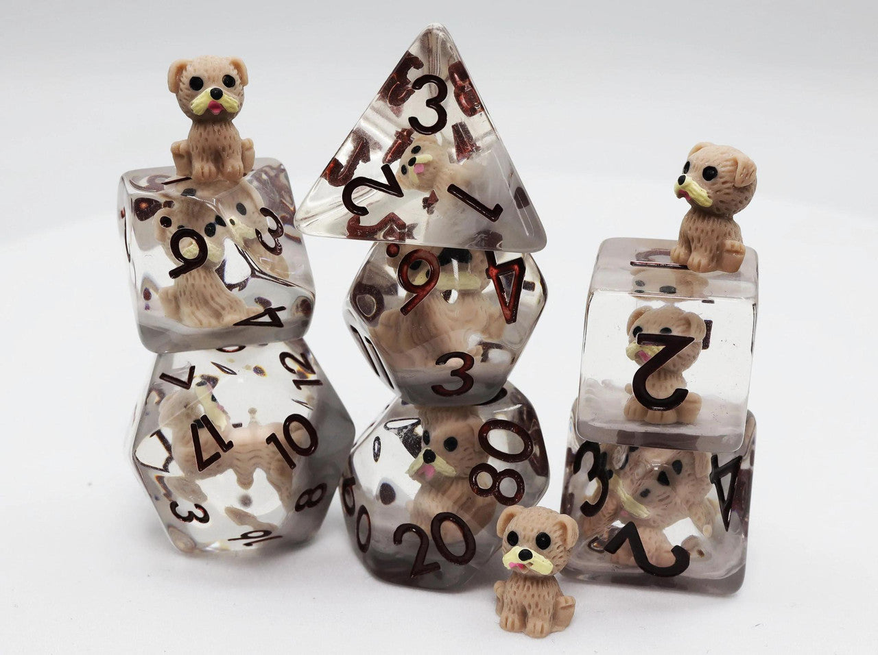 HAZEL THE GOOD DOGGO RPG Dice Set featuring clear polyhedral dice with brown numbers and stacked tiny dog figures inside.