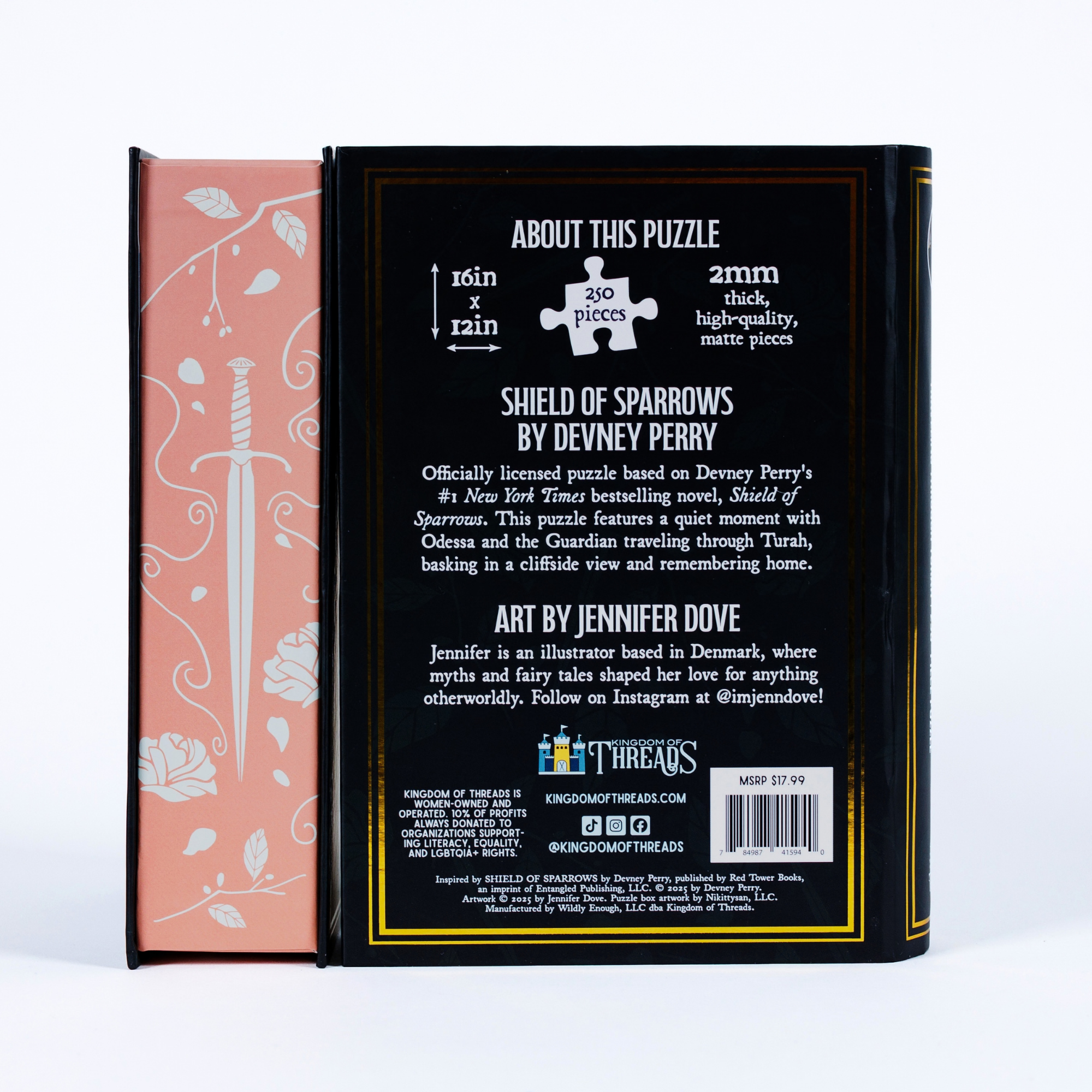 Back of Traveling Through Turah Keepsake Puzzle box showing specs, credits, and floral sword art on a book-shaped box.