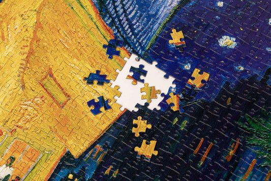Loose pieces and gaps in the 1000-piece Vincent van Gogh Cafe Terrace puzzle.